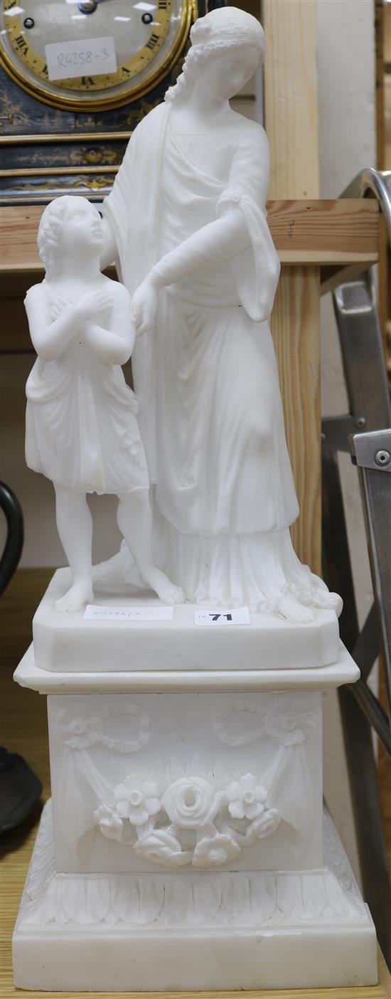 An alabaster figure on a plinth